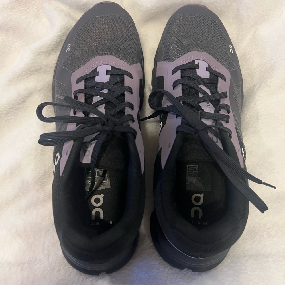 Mens size 9 On Running Black Sneakers with purple accent!